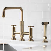 KRAUS Urbix™ Industrial Bridge Kitchen Faucet with Side Sprayer in Brushed Gold, Adjustable Height, Spout Reach: 9-3/4'' D